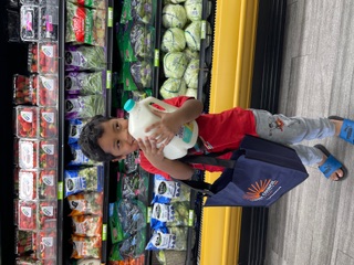 Young boy with gallon of milk (Mother's Nut. Center)